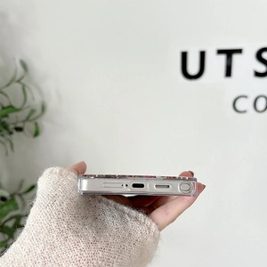 Detail showing precise cutouts for charging port and speaker on glitter Samsung case