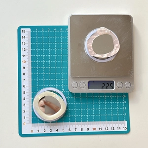 Macro view of marble patterned acetate phone mirror grip measuring 5.5cm for makeup