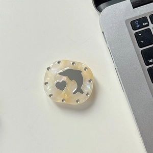 Detail of dolphin rhinestone phone socket with pearl texture and makeup mirror