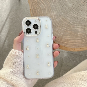 Close-up of clear iPhone case with silver money bag charms and metal camera ring
