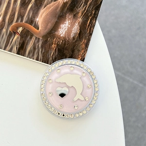 Macro detail of pink glitter phone grip with rhinestones, dolphin and heart mirror