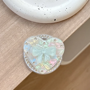 Detail of laser heart phone grip with iridescent finish and blue bow decoration