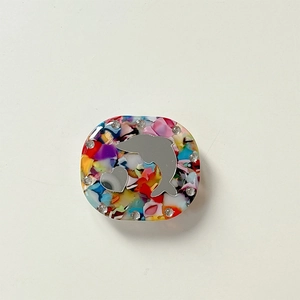 Detailed macro view of a floral acetate phone grip with silver dolphin and rhinestones