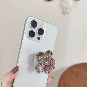 Sparkly glitter flower phone grip socket with resin petals on white smartphone back
