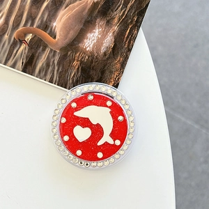 Close-up of red dolphin and heart phone grip with sparkling glitter and rhinestones