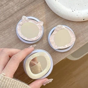 Three minimalist phone grip mirrors with elegant marble shell textures and cat ear shapes