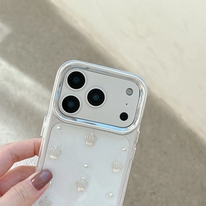 Detail of clear iPhone case featuring a silver 3D crown decoration and shiny glitter