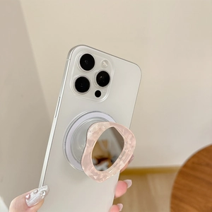 Detail of pink marble resin phone grip with an integrated irregular vanity mirror
