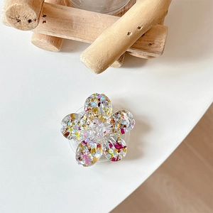 Detail of flower phone grip with colorful glitter and sequins in transparent acrylic