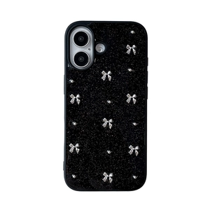 Sparkly black iPhone 17 case with silver 3D bows and pearl studs in sweet-cool style