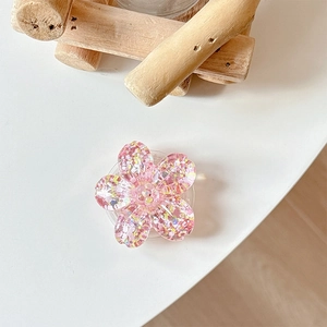 Detail of cherry blossom phone socket with pink glitter and colorful sequins