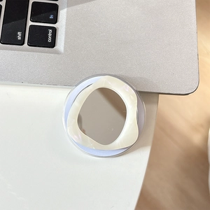 Detail of expandable phone socket with makeup mirror and cream marble pattern ring