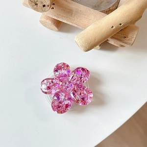 Detailed view of pink glitter flower phone grip with translucent resin cherry blossom petals