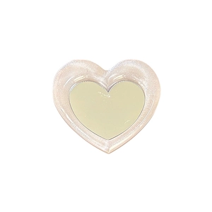 Cute heart-shaped expandable phone grip mirror in pink pearlescent finish for tabletop use