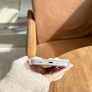 Detailed view of clear phone case bottom with precise cutouts and 3D ribbon decor