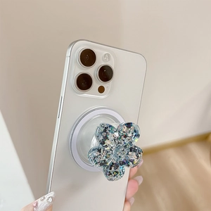 Dettaglio del supporto per cellulare a fiore con paillettes colorate su smartphone bianco