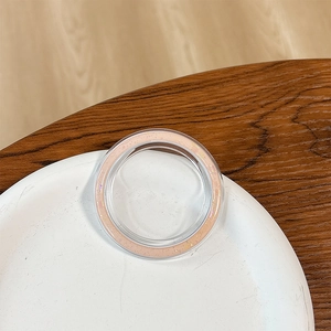 Detailed view of round pink glitter phone socket stand on a white porcelain plate