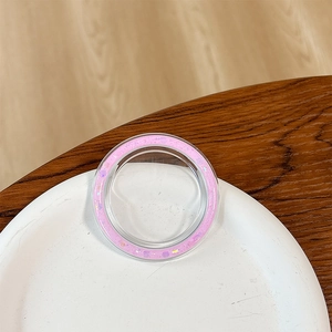 Macro shot of circular phone socket with pink glitter edges and a transparent center