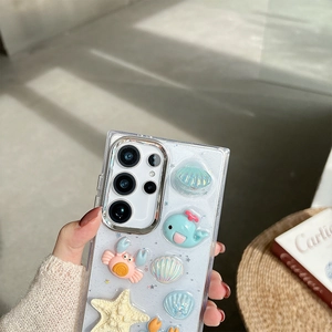 Detail of 3D ocean charms with whales and crabs on a glitter Samsung Galaxy case