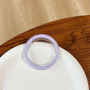 Detailed view of a round purple glitter phone grip base on a clean white tray