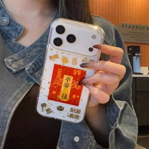 Close-up of clear iPhone case with lucky red charms and gold leaf decorative flakes