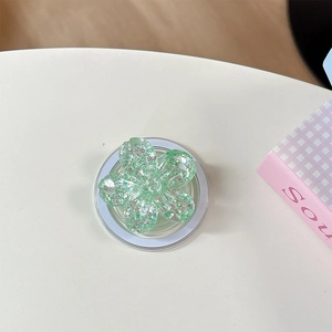 Vista macro del supporto per telefono a fiore verde con glitter e acrilico lucido
