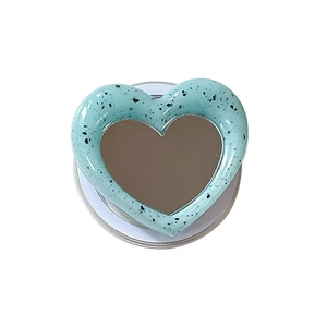 Mint green heart MagSafe phone grip with black marble pattern and built-in vanity mirror
