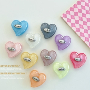 Macro view of 10-color heart-shaped resin phone grips with silver Handmade plaques