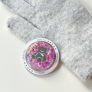 Macro view of magnetic glitter bear phone socket with Gift For You text and sequins