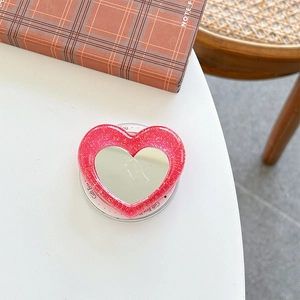 Close-up of heart-shaped glitter phone socket with a built-in mirror and pink sequins