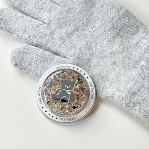 Detail of magnetic glitter bear phone socket featuring gold sequins and gift text