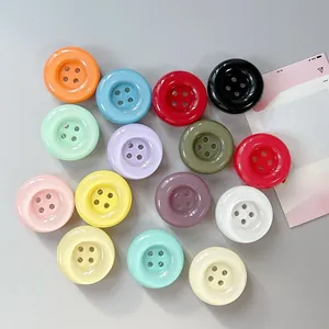 Close-up of colorful round four-hole phone grips in various vibrant glossy finishes