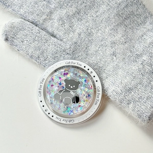 Macro view of magnetic glitter phone grip with a black bear and starry sequins