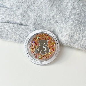 Detail shot of a magnetic phone grip with glittery acrylic bear design and cute text