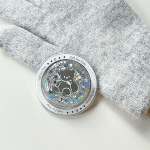 Close-up of glitter-filled liquid bear phone grip with Gift For You star pattern