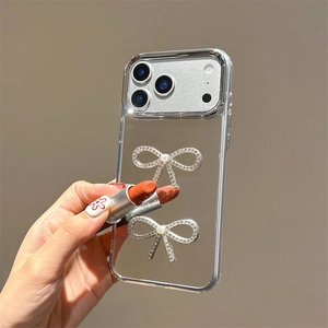 Macro detail of silver bow design on mirror phone case with reflective surface finish