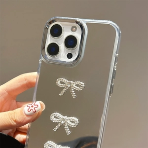 Detail of mirror phone case with three sparkling silver rhinestone bows for iPhone 16 Pro
