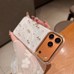 Detail view of pearl white iPhone case with 3D gold embossed roses and metal lens rim