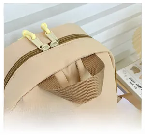 Close-up of durable brown woven handle and smooth yellow double zippers on toddler backpack