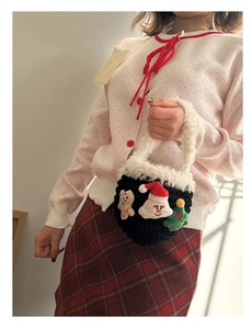 Detail of handmade crochet Christmas mini bag with plush trim and holiday icons