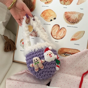 Detail of purple handmade crochet mini bag with plush handle and 3D Santa and Gingerbread man