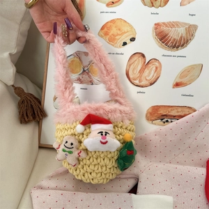 Hand-knitted yellow baby mini bag with plush trim and festive Christmas character patches