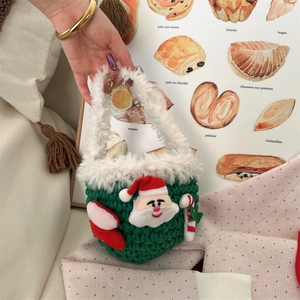 Detail of hand-crocheted green Christmas mini bag with Santa Claus and fur trim