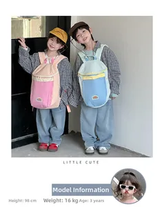 Outdoor shot of kids wearing lightweight color-block backpacks with adjustable straps
