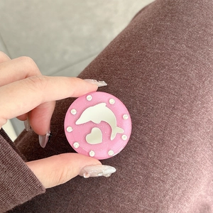 Detailed view of pink glitter phone grip featuring silver dolphin, hearts, and rhinestones