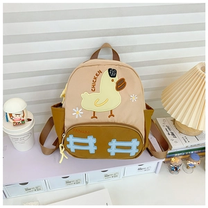 Detail of cute cartoon duck patch and high-quality canvas stitching on children backpack