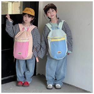 Close-up of color-block canvas backpacks in pink and blue for kids with zipper pockets