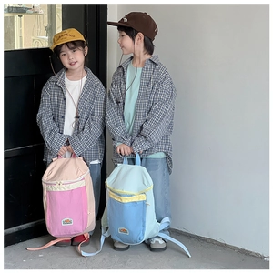 Close-up of children's lightweight backpacks in macaron colors on models