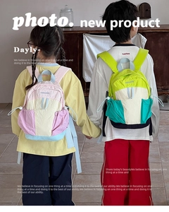 Kids color-block backpack detail showing side drawstring pocket and durable nylon material