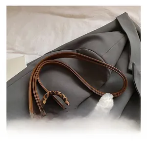 Detail showing the adjustable brown leather strap on leopard print plush backpack